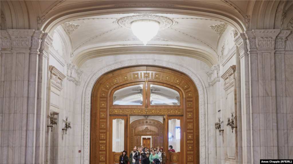 Екскурзовод води туристи през коридор в парламента на Букурещ на 12 януари.