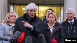 Lawyer Genri Reznik addresses the media alongside members of the Moscow Helsinki Group after the ruling to liquidate the storied human rights organization, in Moscow on January 25.