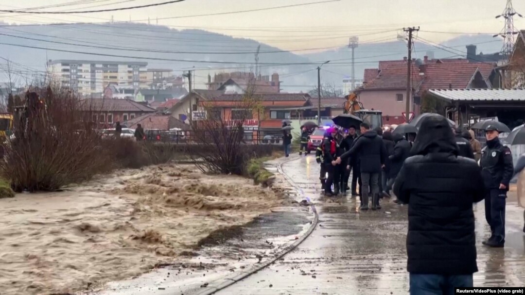 People stand by the river in Novi Pazar, Serbia, on January 19.