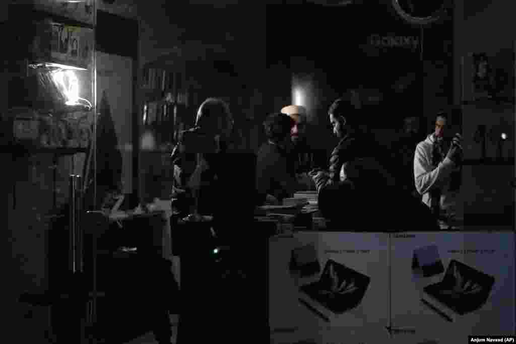 Shopkeepers in Islamabad wait out the blackout. Prime Minister Shahbaz Sharif has ordered a probe into the outage.