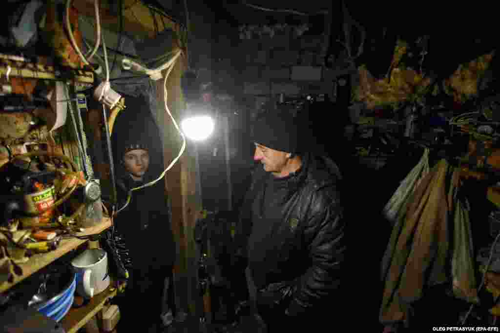 Evelina stands in the basement chamber that she shares with Leonid (right), who used it as a workshop before the war. The mayor of Lyman, Oleksandr Zhuravlov, reportedly said that 3,000 residents have returned since the town was liberated.