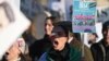 Protesters hold placards at a march in central London on January 21 against the Islamic Revolutionary Guards Corps (IRGC).