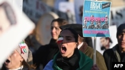 Protesters hold placards at a march in central London on January 21 against the Islamic Revolutionary Guards Corps (IRGC).