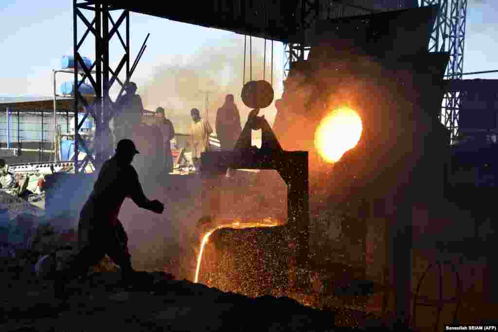 Afghan laborers work at an iron factory in Kandahar Province.