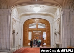 Egy idegenvezető vezeti a turistákat a bukaresti parlament egyik folyosóján január 12-én