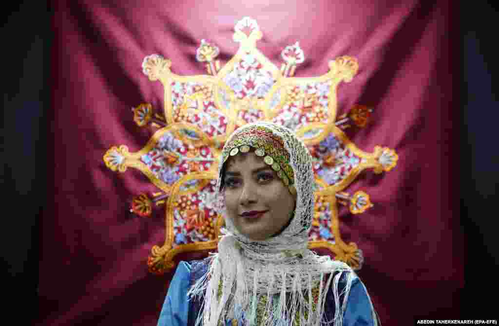 An Iranian woman wearing a traditional Gilaki costume attends the 16th International Exhibition of Tourism and Related Industries at Tehran&rsquo;s international exhibition complex in Tehran.