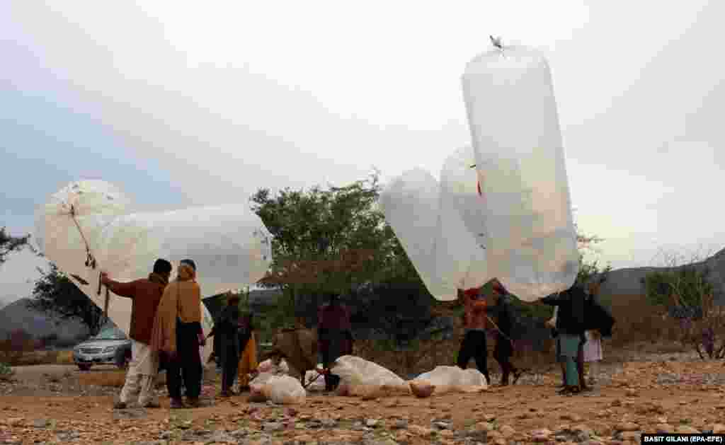 Local residents fill up plastic bags with natural gas to be used for cooking food at home in the Karak district of Pakistan&#39;s Khyber Pakhtunkhwa Province. The government has not established any proper infrastructure for providing natural gas to local residents or surrounding areas, so people are putting their lives at risk just to use natural gas as a means of cooking their food at home. People have been using a hose to extract gas from main supply lines instead of drilling.