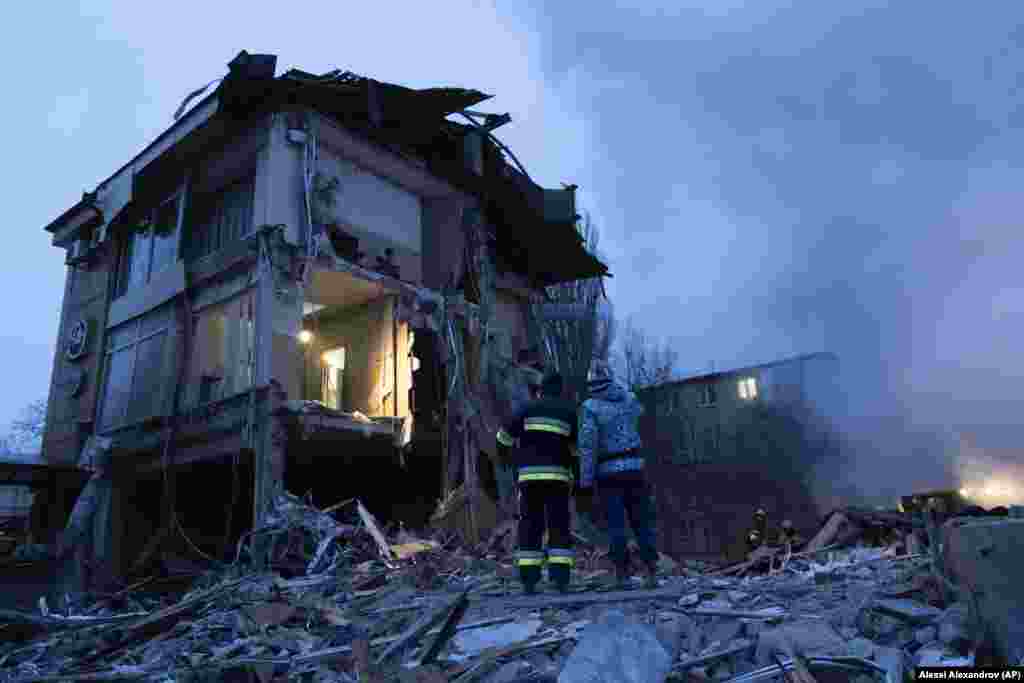 Smoke rises as Donetsk&#39;s emergency employees work at the site of a shopping center destroyed in what Russian officials in Donetsk, Ukraine, said was shelling by Ukrainian forces.