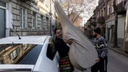 Aleksei Antropov carries his double bass as he&nbsp;moves into his new apartment in Tbilisi, Georgia, on December 26.<br />
<br />
The 29-year-old classical musician was among hundreds of thousands of draft-age men who fled Russia when the Kremlin announced a &quot;partial&quot; mobilization in September 2022.