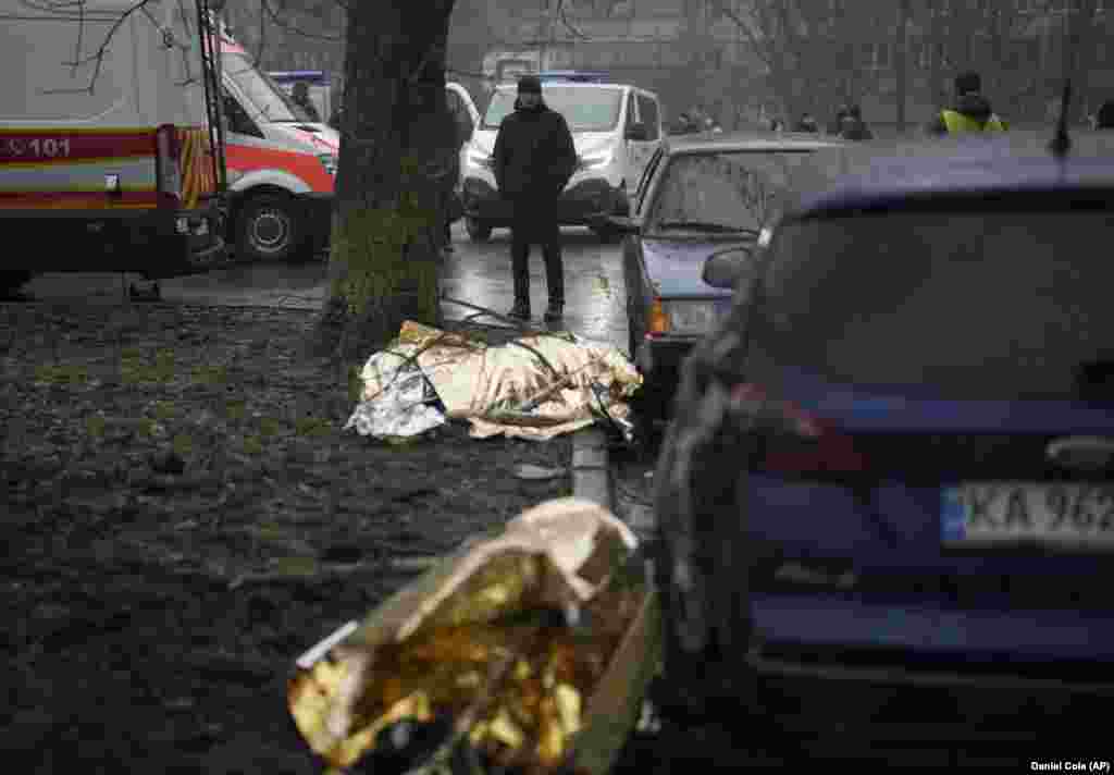 Bodies of the victims lie on the ground at the scene where the helicopter crashed in Brovary.