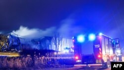 Fire engines are seen at the site of a blaze that broke out at a drone factory on the outskirts of Latvia's capital, Riga, on February 7. 