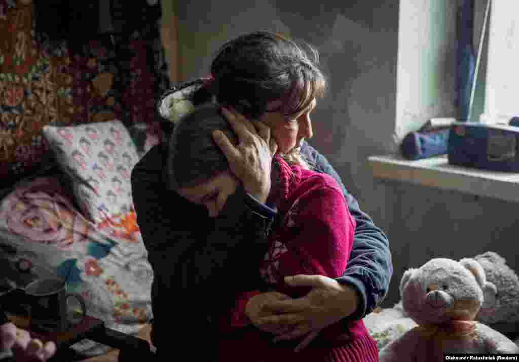 Olha hugs her granddaughter Arina, 6, while saying goodbye before Arina&#39;s evacuation from the frontline city of Bakhmut amid Russia&#39;s attack on Ukraine on January 31.