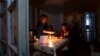 Nagorno-Karabakh - A woman and her son have a dinner at their home in Stepanakert in the absence of electricity and gas, January 18, 2023.