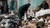 During a lull in shelling on February 8, Avdiyivka residents, such as 71-year-old Lyubov Stepanova (right), quickly collect much-needed firewood. Russian forces are slowly gaining ground in the Donestk region.