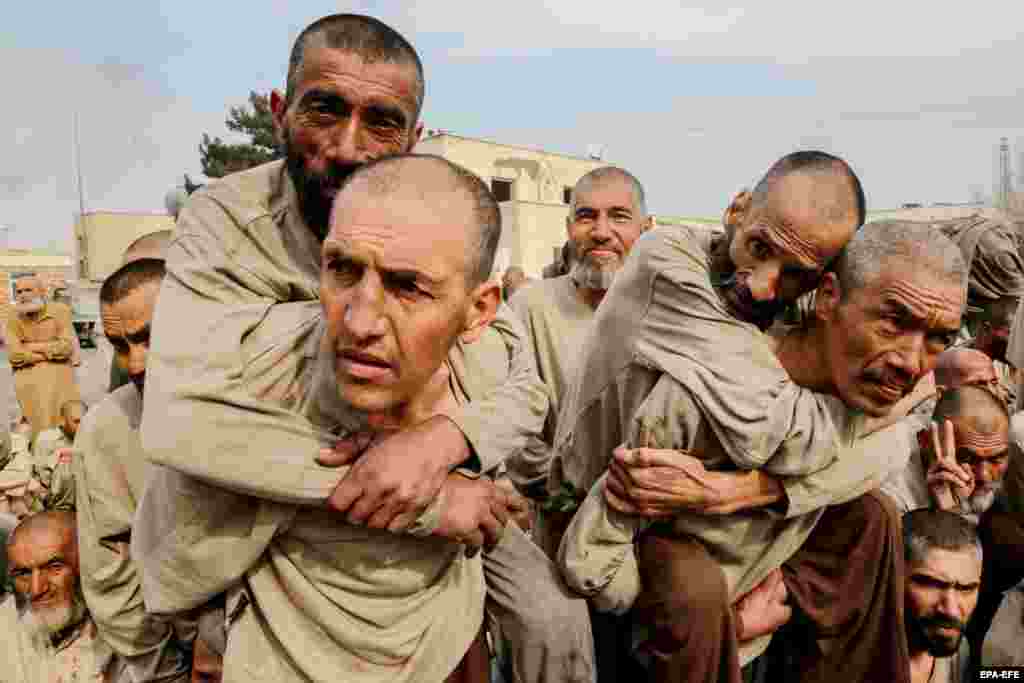 Newly admitted drug addicts wait for registration at a rehabilitation center in Kabul, Afghanistan.