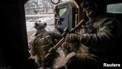Ukrainian soldiers exit an armored personnel carrier in the frontline town of Bakhmut on February 9.