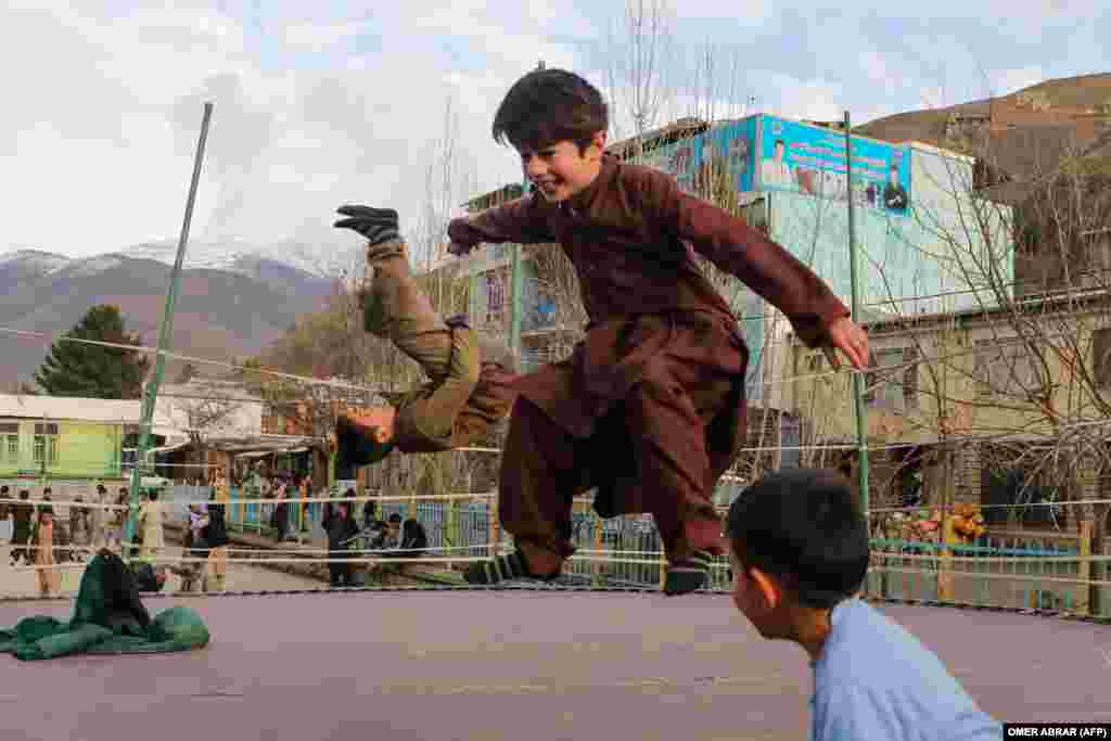 Children jump on a trampoline in the Fayzabad district of Afghanistan&#39;s northeastern Badakhshan Province.