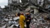 Членовете на екип за спешни случаи спират за момент, докато търсят оцелели в разрушена сграда в Адана, Турция, 6 февруари 2023 г.