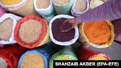 A man sells lentils at a wholesale grocery market in Karachi.