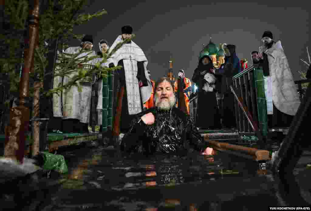 A priest takes a dip near the Church of the Holy Trinity in Moscow.