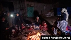 People gather around a fire after an earthquake in Khoy, Iran, on January 29.