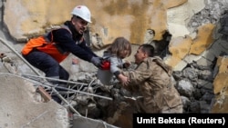 Турецкие спасатели вытаскивают 5-летнего мальчика из развалин. Провинция Хатай, город Антакья, 6 февраля 2023 года.