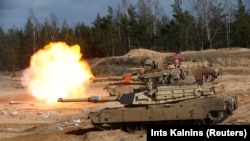 A U.S. Army M1A1 Abrams tank fires during NATO military exercises in Latvia in 2021.