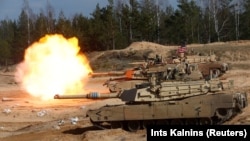 A U.S. M1A1 Abrams tank fires during NATO military exercises in Latvia in 2021. Washington said 31 of the battle tanks would be sent to Ukraine.