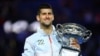 Serbia's Novak Djokovic celebrates with the trophy after winning the Australian Open last month.