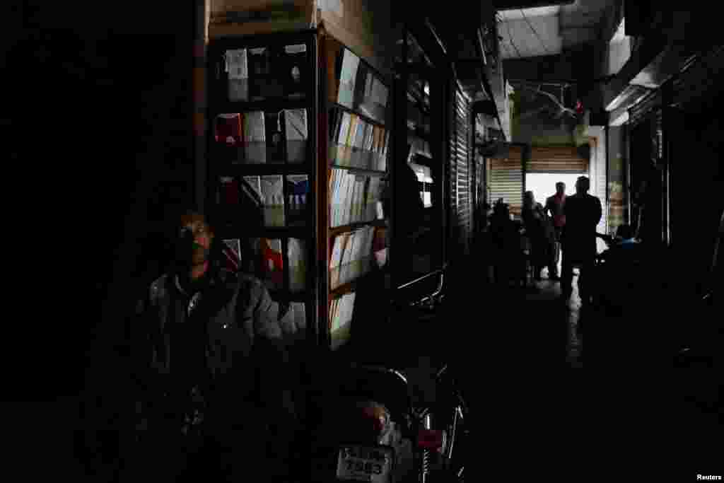 Struja je nestala u južnom lučkom gradu Karačiju, glavnom gradu Islamabadu, Lahoreu na istoku i Pešavaru na sjeveru zemlje. na fotografiji: prodavač u polumraku sjedi ispred radnje u Karačiju, 23. januar 2023.