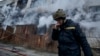 A Ukrainian firefighter takes a break following Russian shelling that hit an industrial area in Kherson on February 5.