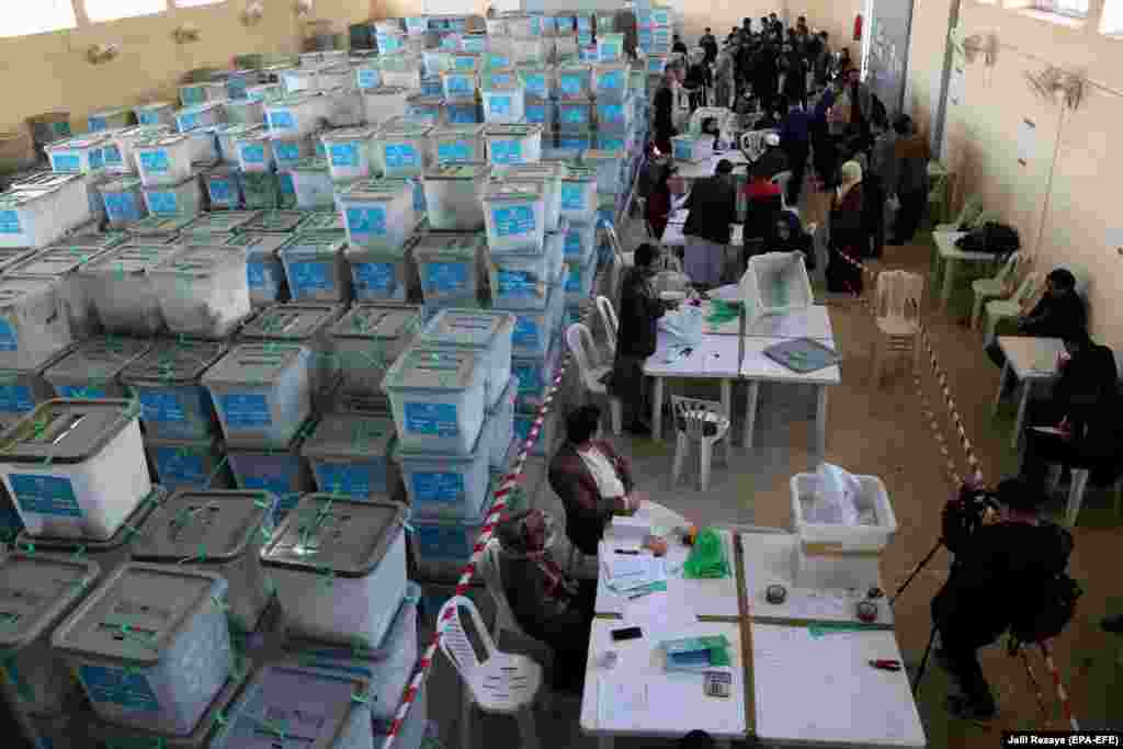 Workers from the Afghan Independent Election Commission count ballot papers in Herat from the country's September 28 presidential election. The commission plans to recount and audit the votes from more than 8,000 of 26,000 polling stations. The release of the results has been hampered by widespread accusations of misconduct during voting and technical problems with transferring ballot papers and data from the biometric voter-verification system. (epa-EFE/Jalil Rezayee)