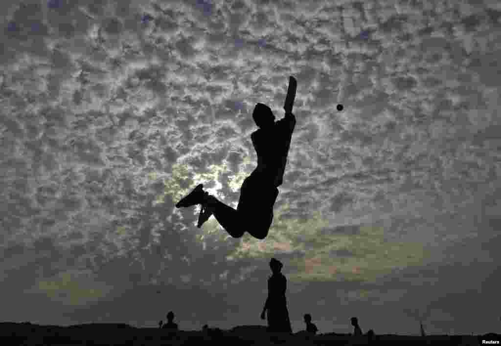 Indian boys play cricket on Marina beach in the southern city of Chennai on May 24. (Reuters/Babu)