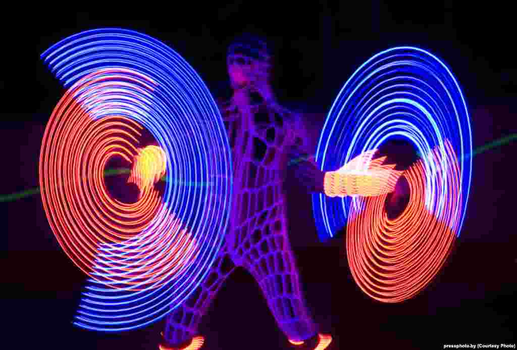 Performers at a neon show in Minsk. Photo by Natallya Ablazhey