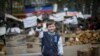 A boy with a toy gun poses for picture in front of barricades at police headquarters in the eastern Ukrainian town of Slovyansk. (Reuters/Gleb Garanich)