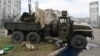 Bodies of Russian servicemen, wearing Ukrainian uniforms, inside and beside a vehicle. They were shot during a skirmish in the Ukrainian capital, Kyiv, on February 25.