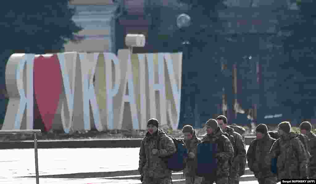 Ukrainian servicemen walk past a sign reading &quot;I Love Ukraine&quot; at Independence Square in Kyiv, the site of large protests in 2014 that led to the ouster of pro-Russia President Viktor Yanukovych.