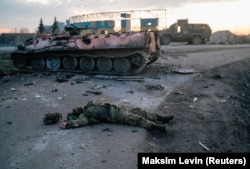 The body of a soldier without insignia, who the Ukrainian military said was a Russian Army serviceman, lies on a road outside the city of Kharkiv early in the invasion.