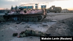 The body of a soldier, who the Ukrainian military claim is a Russian Army serviceman killed in fighting, lies on a road outside the city of Kharkiv on February 24.