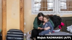 A woman and a girl at a temporary accommodation point for Ukrainian refugees in Przemysl, Poland, on February 26, 2022.