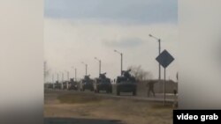 Man tries to stop Russian military convoy with his bare hands as Russian invasion of Ukraine continues. (screen grab)