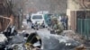 Украінскі салдат разглядае аскепкі зьбітага самалёта ў Кіеве 25 лютага