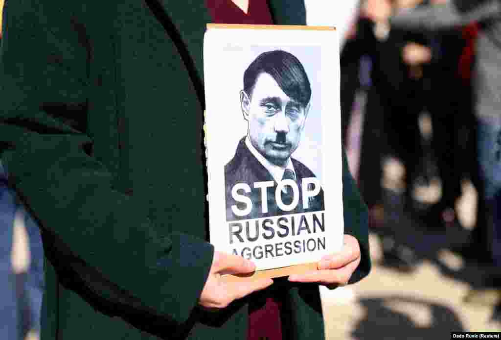 A protester holds a placard in Sarajevo on February 25.