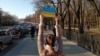Жанчына з плякатам у падтрымку Ўкраіны ў цэнтры Менску 27 лютага 