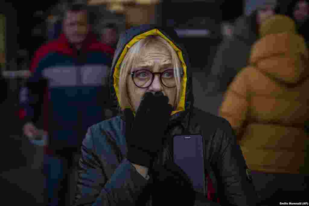 A woman reacts to sirens announcing new attacks outside a supermarket in central Kyiv, Ukraine.&nbsp;