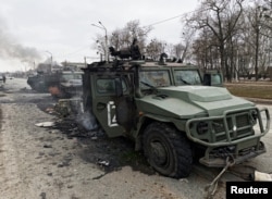 Destroyed Russian Army Tigr-M all-terrain infantry vehicles are seen on a road in Kharkiv on February 28, 2022.