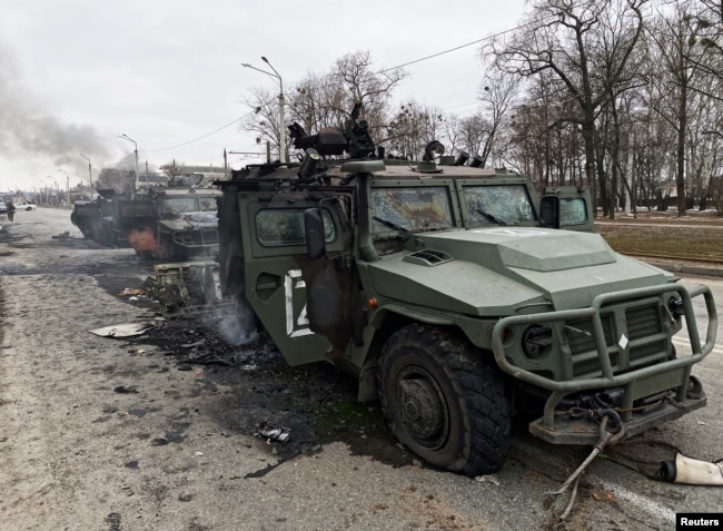 Destroyed Russian Army Tigr-M all-terrain infantry vehicles are seen on a road in Kharkiv on February 28, 2022.