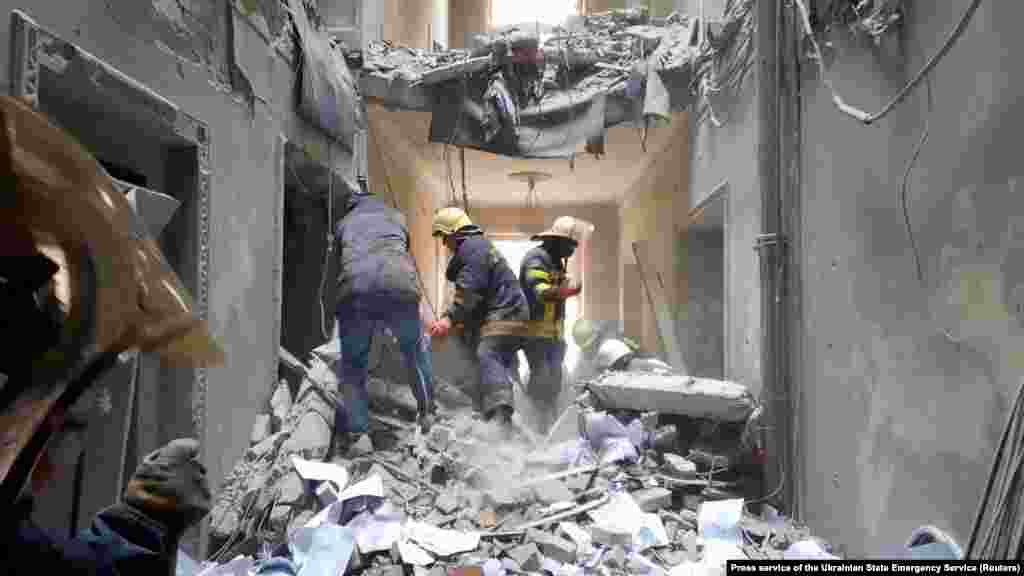 Rescuers are seen in a building in Kharkiv that city officials said was damaged by a Russian missile on March 1.