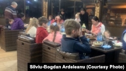 Ukrainian children who fled Ukraine with their mothers join a meal at Silviu-Bogdan Ardeleanu's hotel/boardinghouse on February 27.