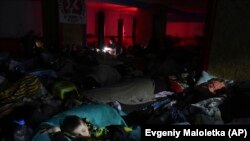 UKRAINE - People sleep in the improvised bomb shelter in a sports center, which can accommodate up to 2000 people, in Mariupol, Ukraine, late Sunday, Feb. 27, 2022